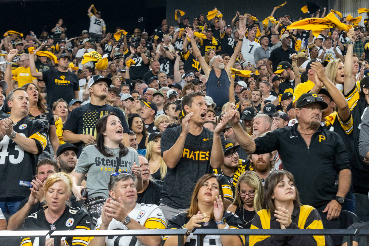 Pittsburgh Steelers fans wave their towels and celebrate after a touchdown is scored by wide re ...