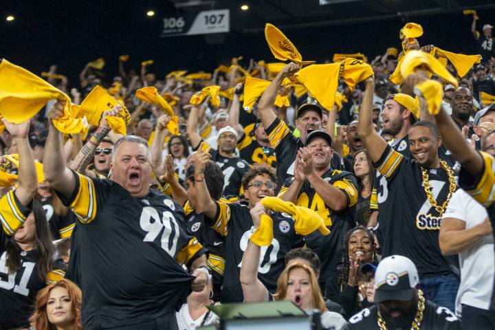 Pittsburgh Steelers fans wave their towels and celebrate after a touchdown is scored by wide re ...