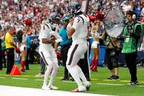 Houston Texans quarterback C.J. Stroud (7) and wide receiver Tank Dell (3) celebrate after a pl ...