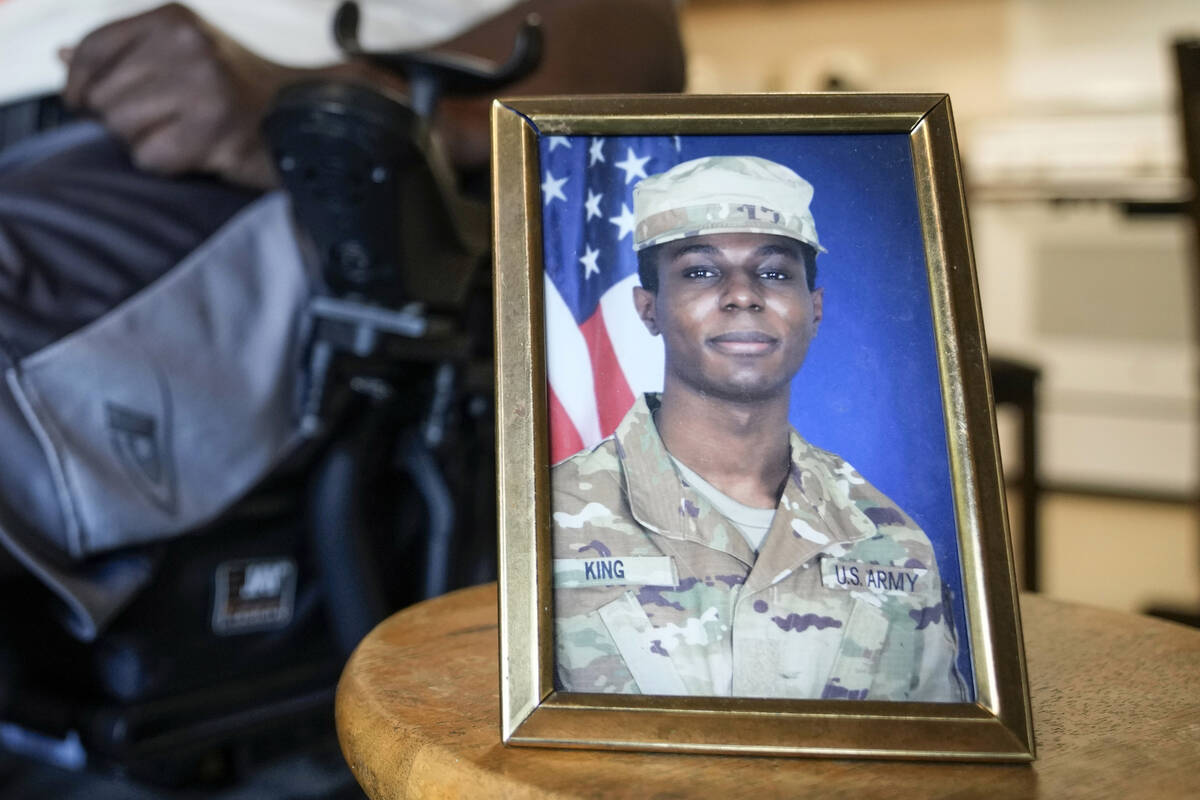 FILE - A portrait of American soldier Travis King is displayed as his grandfather, Carl Gates, ...