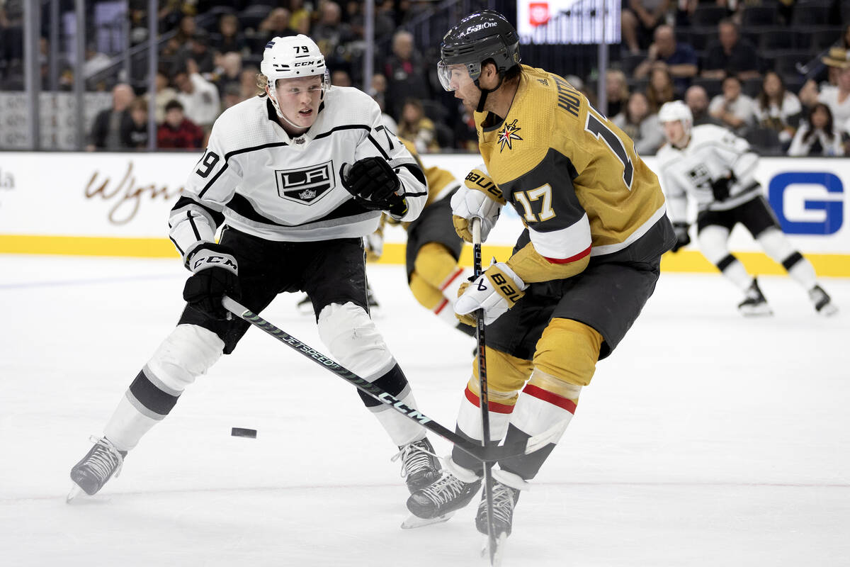 Golden Knights defenseman Ben Hutton (17) anticipates the puck while Kings center Samuel Heleni ...