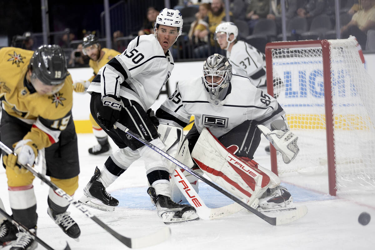 Kings forward Mikhail Maltsev (50) and goaltender Jean-Francois Berube (85) fend off a shot by ...