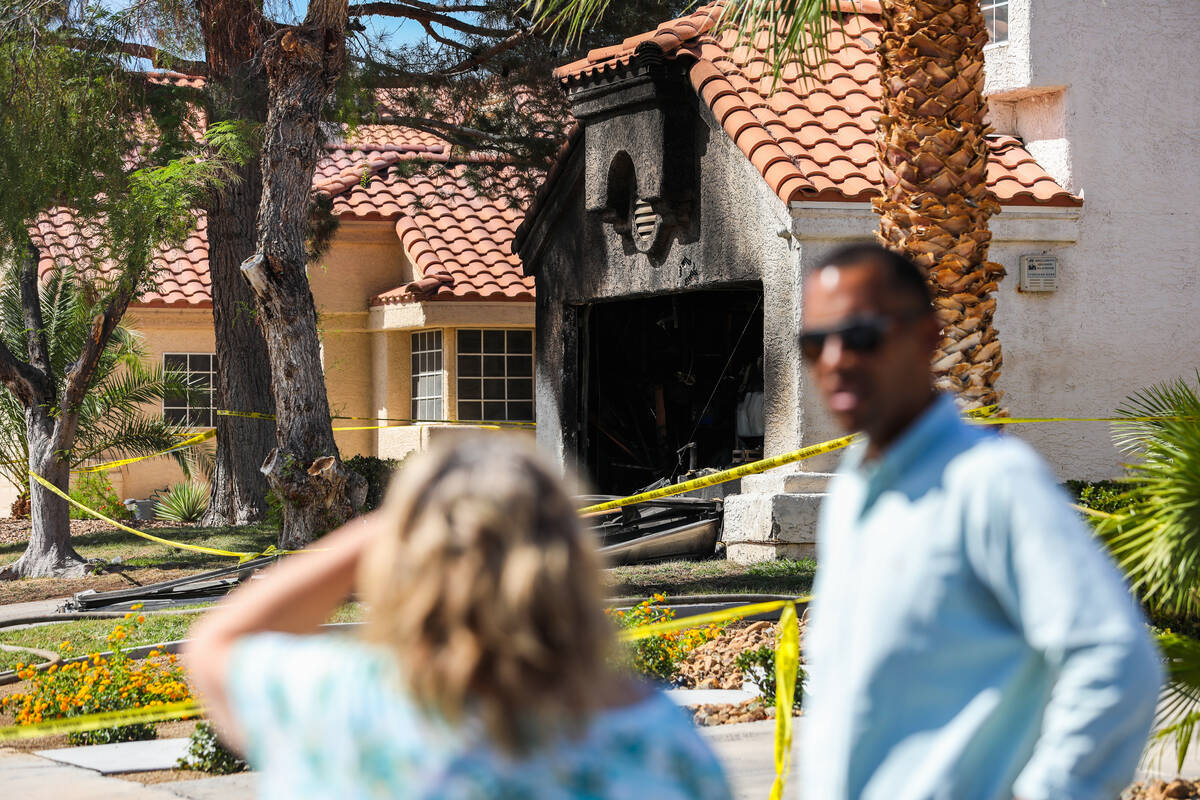 Neighbors look upon a home on the 1900 block of Kransten Drive in Henderson where one person wa ...