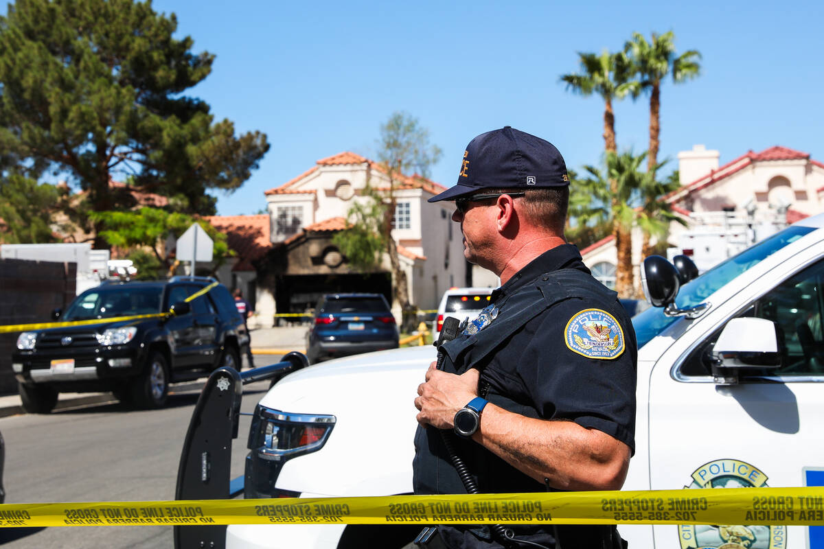 Police block off the 1900 block of Kransten Drive in Henderson in the aftermath of a house fire ...