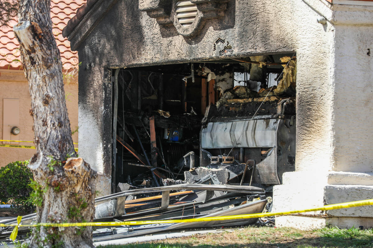 Henderson police and firefighters investigate the inside of a home demolished by a fire, which ...