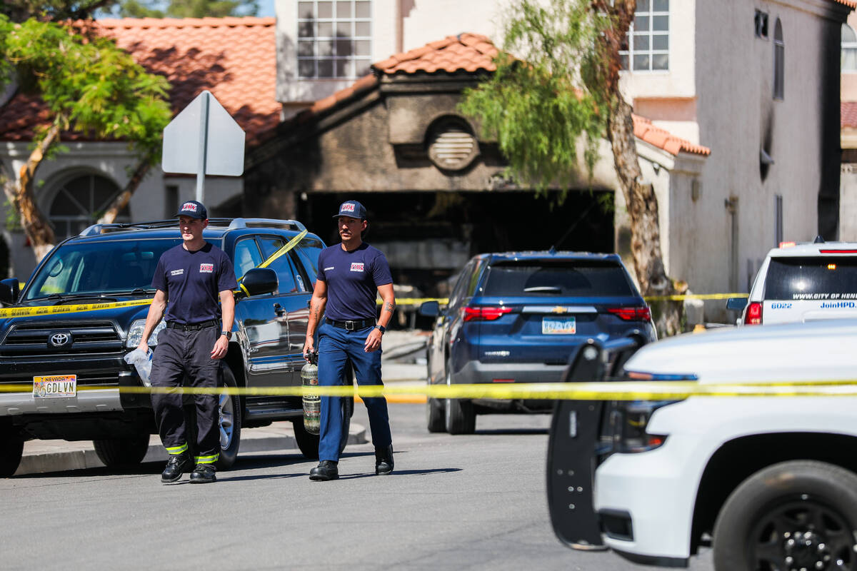 Police block off the 1900 block of Kransten Drive in Henderson in the aftermath of a house fire ...