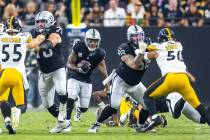 Raiders running back Josh Jacobs (8) looks to break through the line against the Pittsburgh Ste ...