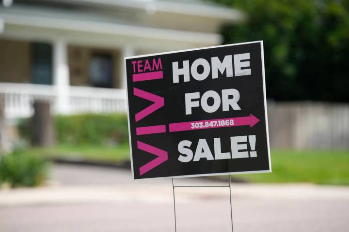 A for sale sign stands outside a single-family residence on Sunday, June 18, 2023, in Denver. O ...