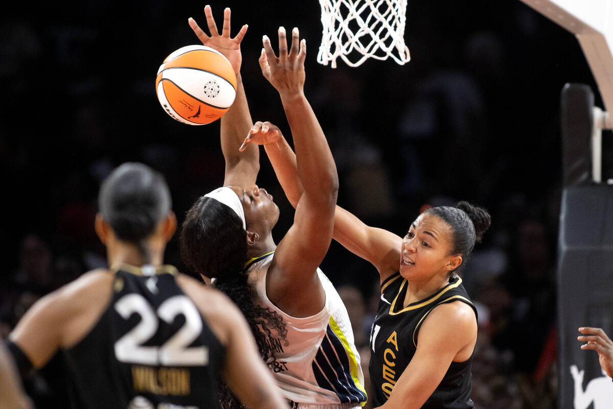 Las Vegas Aces center Kiah Stokes (41) swats down a shot by Dallas Wings center Kalani Brown (2 ...