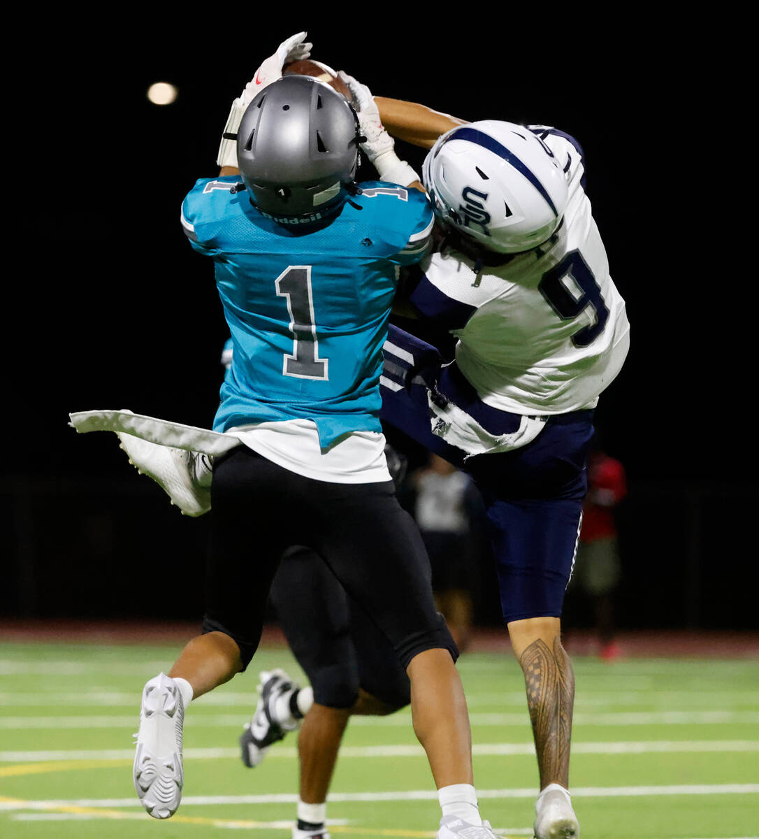 Silverado High Tristan Hudson (1) catches a pass as Shadow Ridge High Jonah Ruiz (9) defends du ...