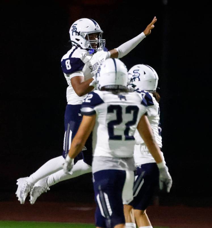 Shadow Ridge quarterback Coen Coloma (8) celebrates with his teammates after scoring a touchdow ...