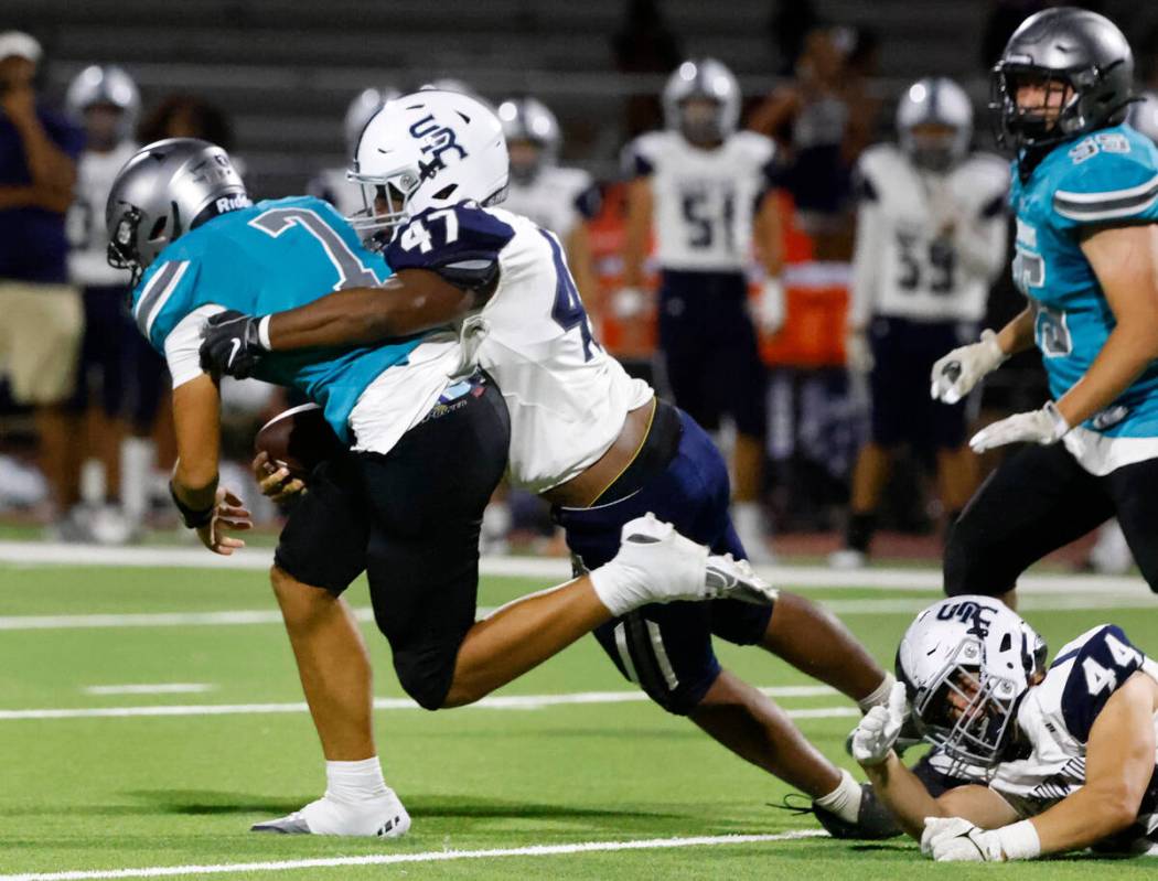 Shadow Ridge Enius Young (47) takes down Silverado High quarterback Dillion Elliot (7) during t ...