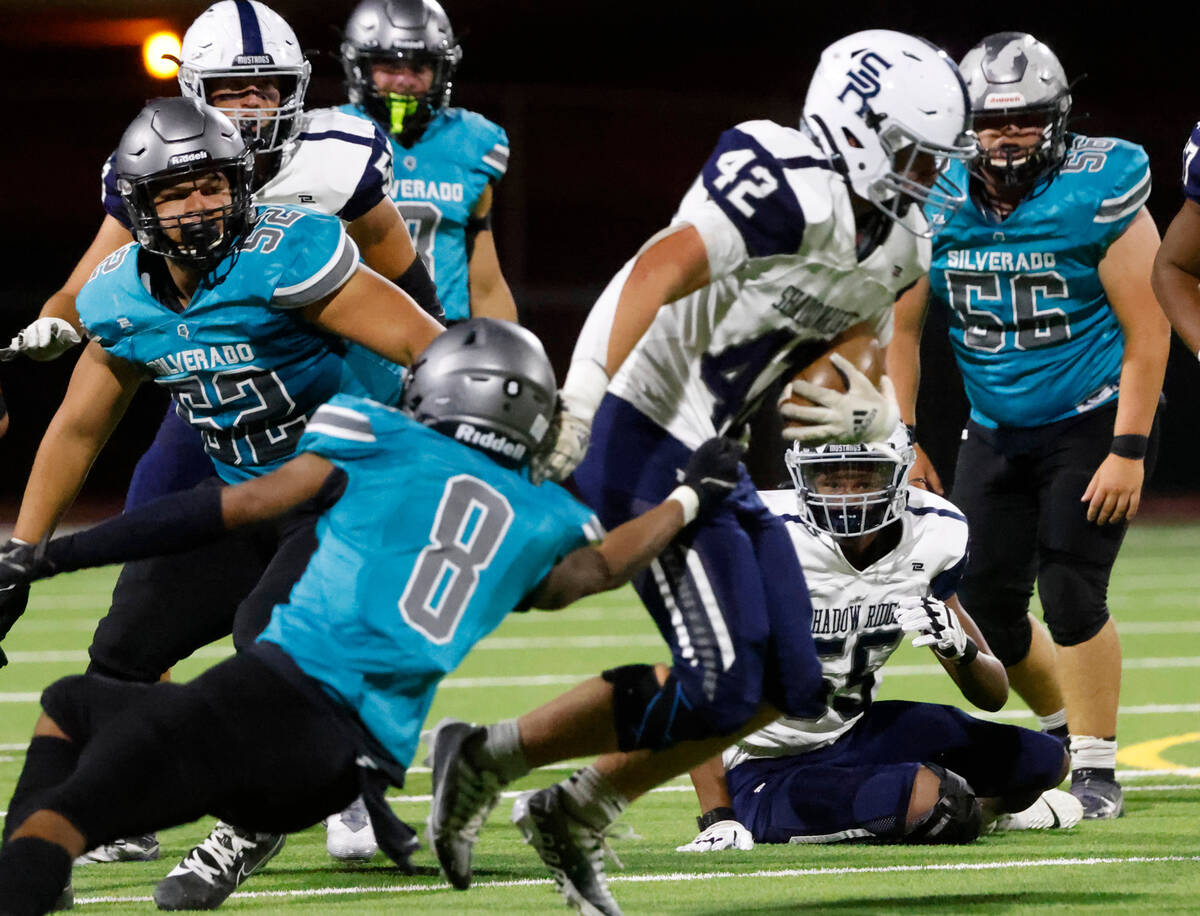 Shadow Ridge High Evan Cannon (42) avoids a tackle from Silverado High Blake Sutton (8) during ...