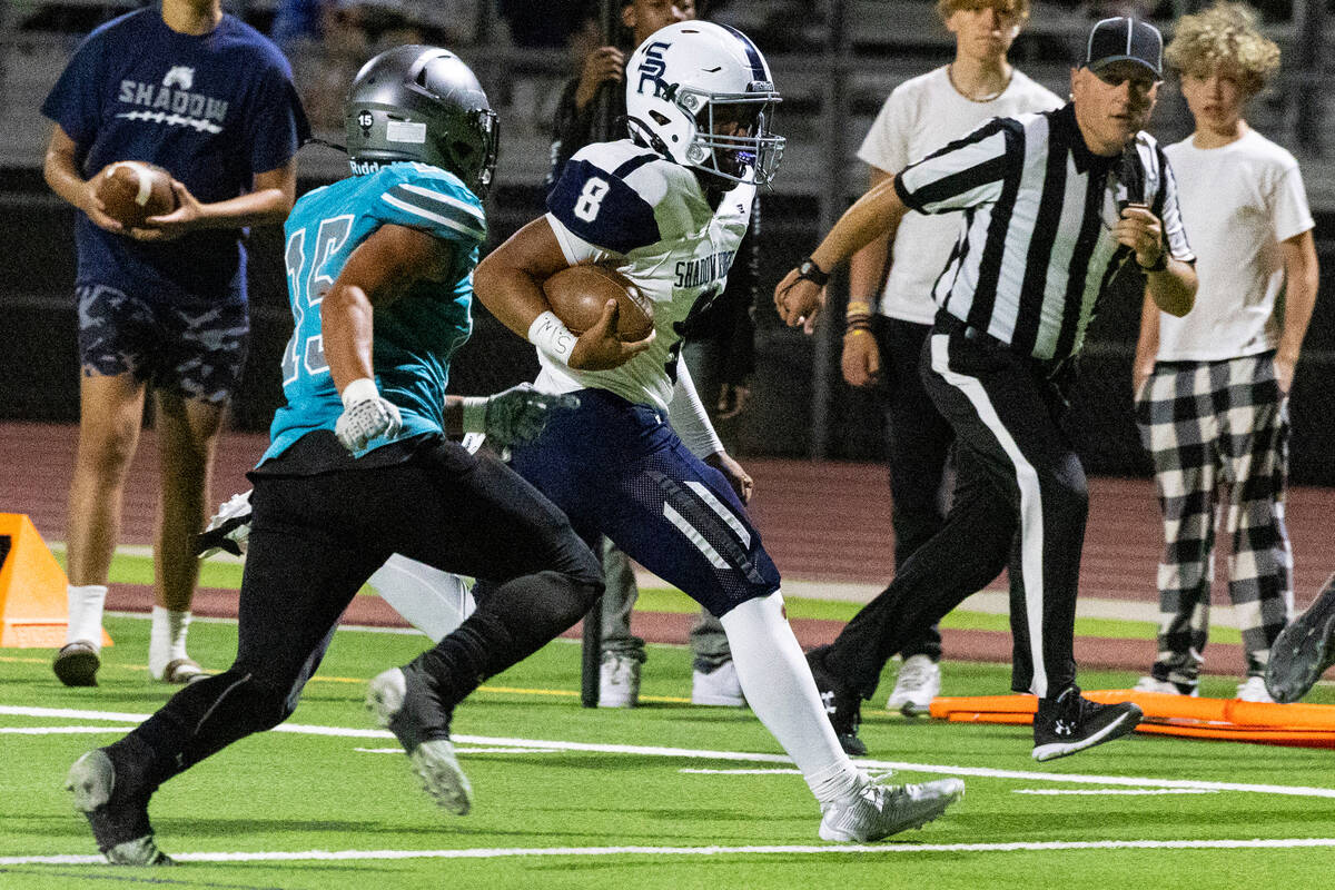 Shadow Ridge High quarterback Coen Coloma (8) chased by Silverado High Kaina Crisostomo (15) du ...