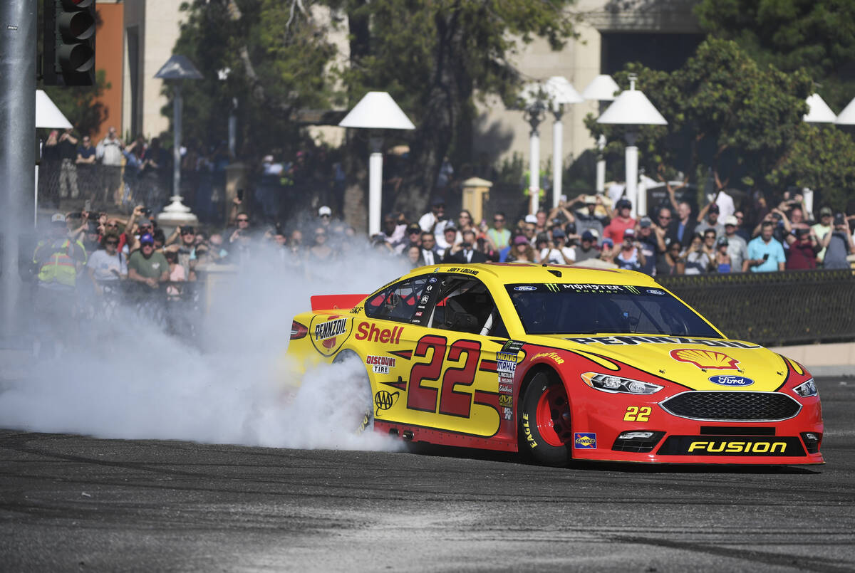 Joey Logano creates a plume of smoke during the 2018 NASCAR Burnout Blvd event on the Las Vegas ...