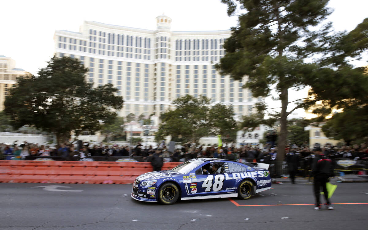 Jimmie Johnson makes a pit stop during a victory lap on the Las Vegas Strip during NASCAR Champ ...