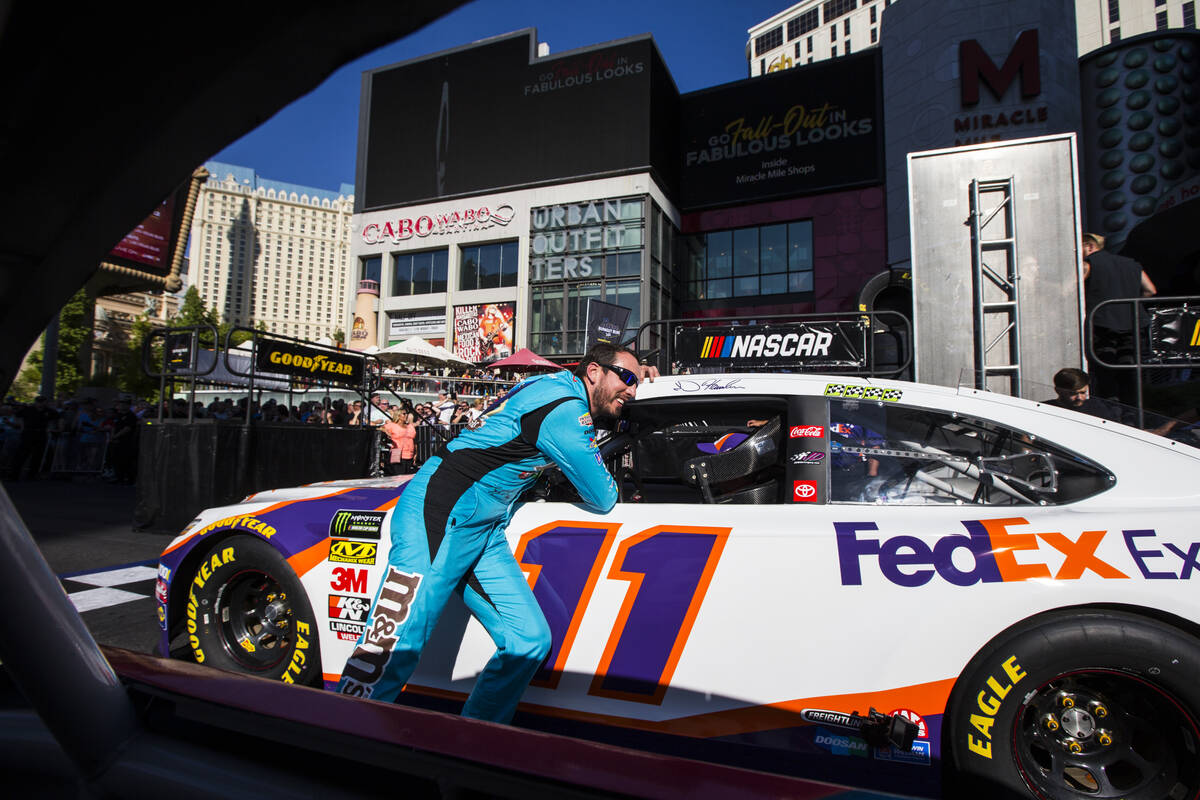 Kyle Busch talks with Denny Hamlin before partaking in the NASCAR America Burnout Boulevard eve ...