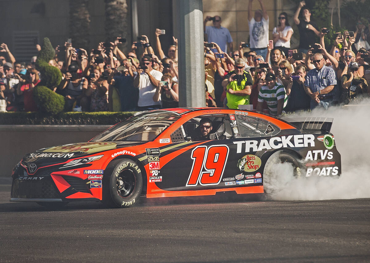 Martin Truex Jr. does a burnout at the intersection of East Sands Avenue and South Las Vegas Bo ...
