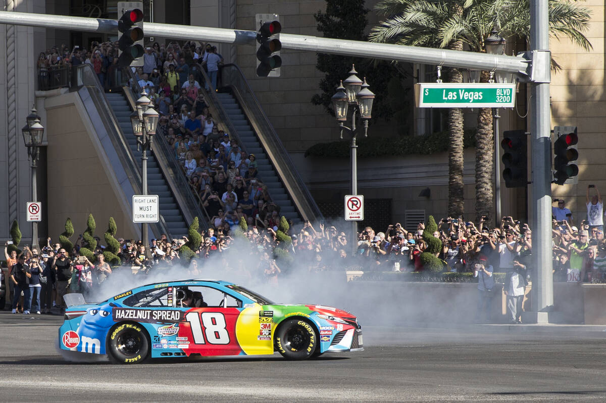 Kyle Busch does a burnout at the intersection of East Sands Avenue and South Las Vegas Boulevar ...