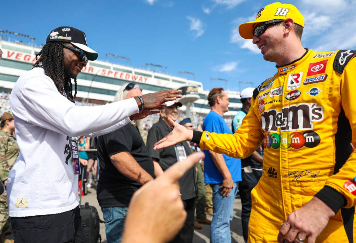 Honorary pace car driver Davante Adams of the Raiders greets driver Kyle Busch before last year ...