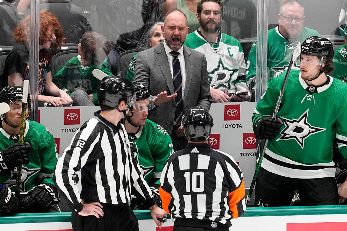Dallas Stars head coach Peter DeBoer, center rear, shouts at an official during the third perio ...