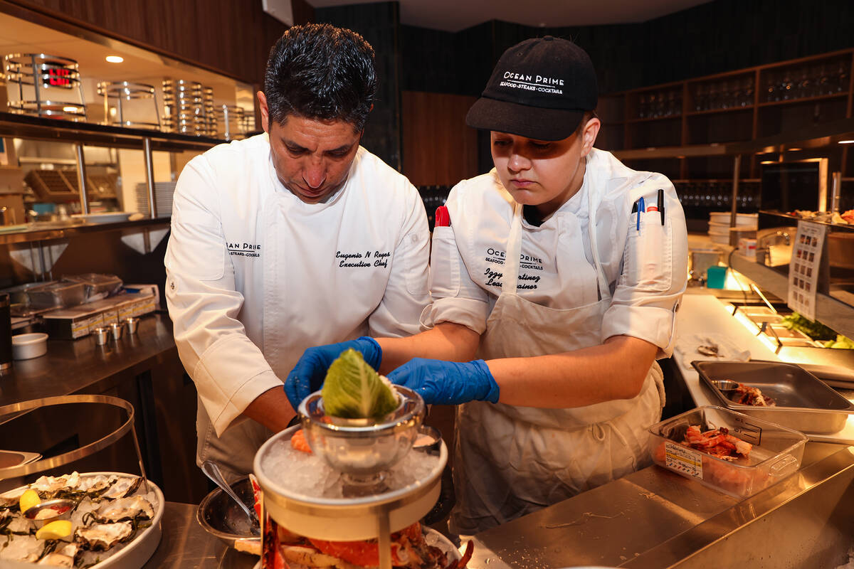 Executive Chef Eugenio Reyes, left, and Izzy Martinez, right, a lead trainer, puts together the ...