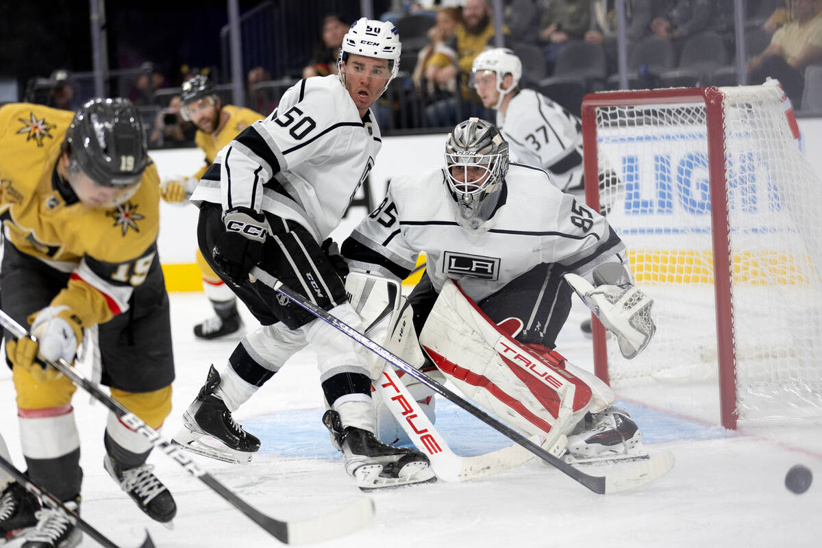 Kings forward Mikhail Maltsev (50) and goaltender Jean-Francois Berube (85) fend off a shot by ...