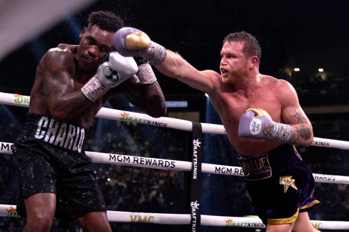 Canelo Alvarez hits Jermell Charlo during an undisputed world super middleweight title boxing b ...