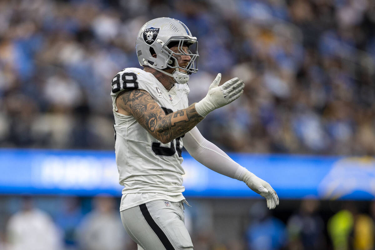 Raiders defensive end Maxx Crosby (98) celebrates his sack of Los Angeles Chargers quarterback ...