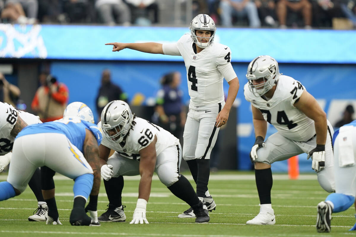 Las Vegas Raiders quarterback Aidan O'Connell (4) signals during the first half of an NFL footb ...