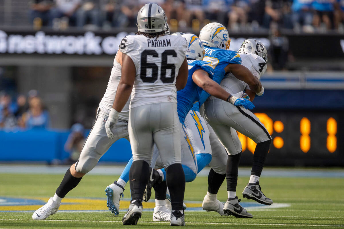 Los Angeles Chargers linebacker Khalil Mack (52) sacks Raiders quarterback Aidan O'Connell (4) ...