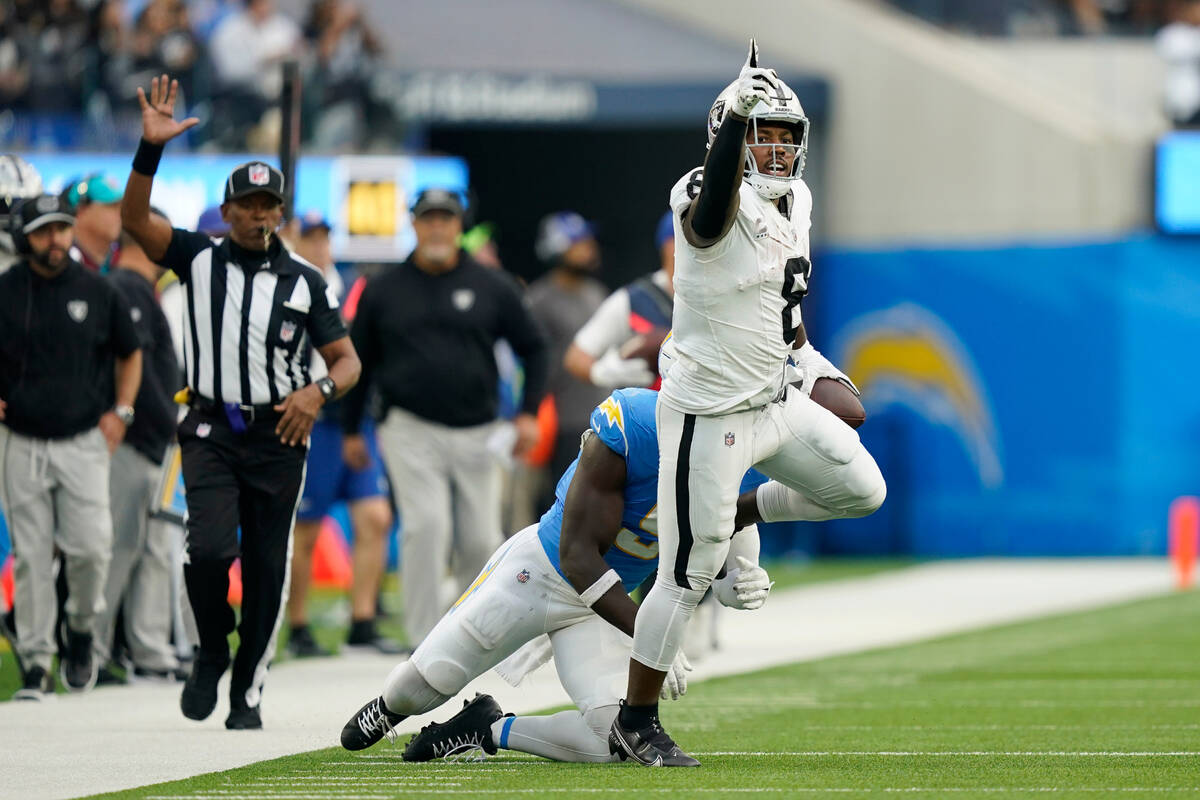 Las Vegas Raiders running back Josh Jacobs (8) points as he gets a first down during the second ...