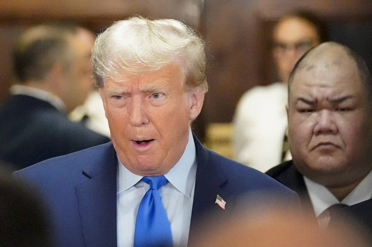 Former President Donald Trump, center, arrives at New York Supreme Court, Monday, Oct. 2, 2023, ...