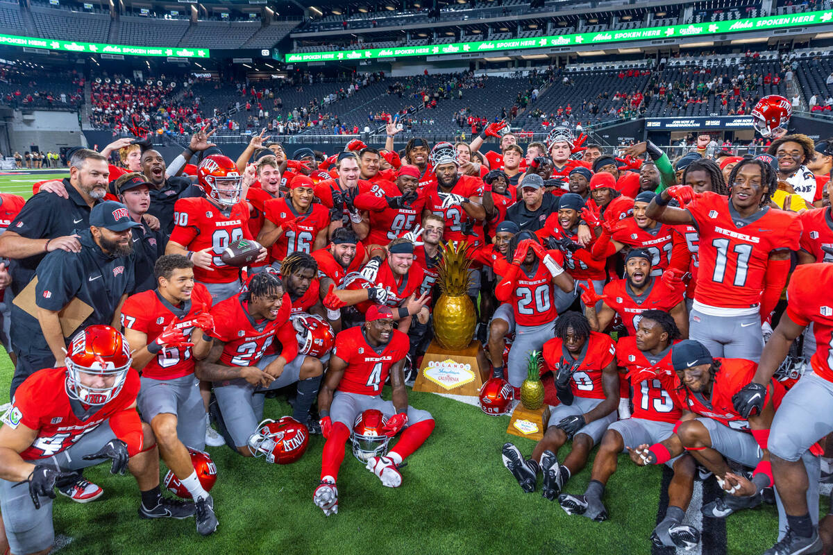 UNLV players and coaches celebrate their win in the Ninth Island Showdown against Hawaii follow ...