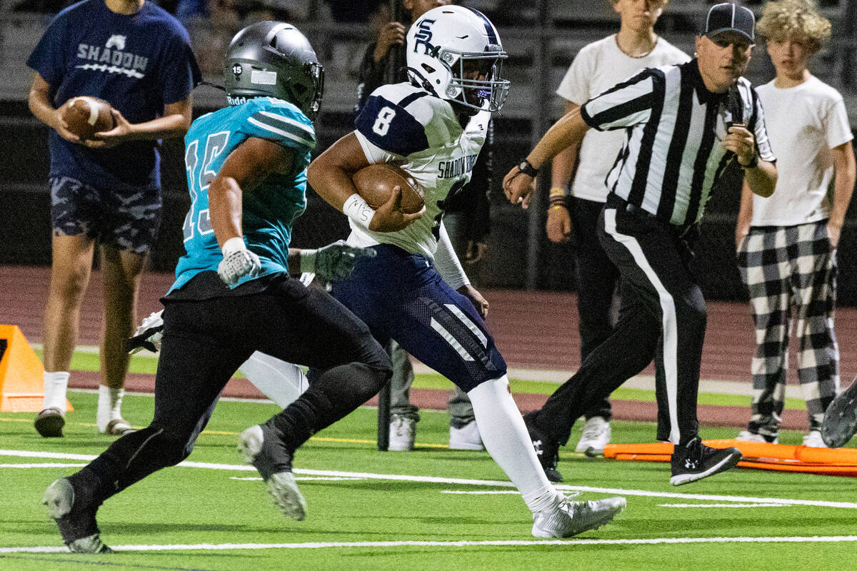 Shadow Ridge High quarterback Coen Coloma (8) is chased by Silverado High's Kaina Crisostomo (1 ...