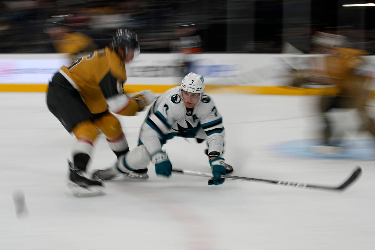 San Jose Sharks center Nico Sturm (7) frights for the puck with Vegas Golden Knights defenseman ...