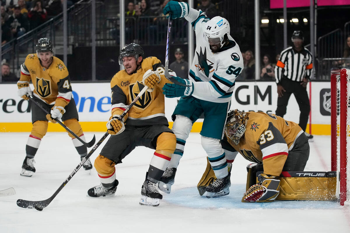 San Jose Sharks' Givani Smith (54) vies for the puck with Vegas Golden Knights defenseman Brayd ...