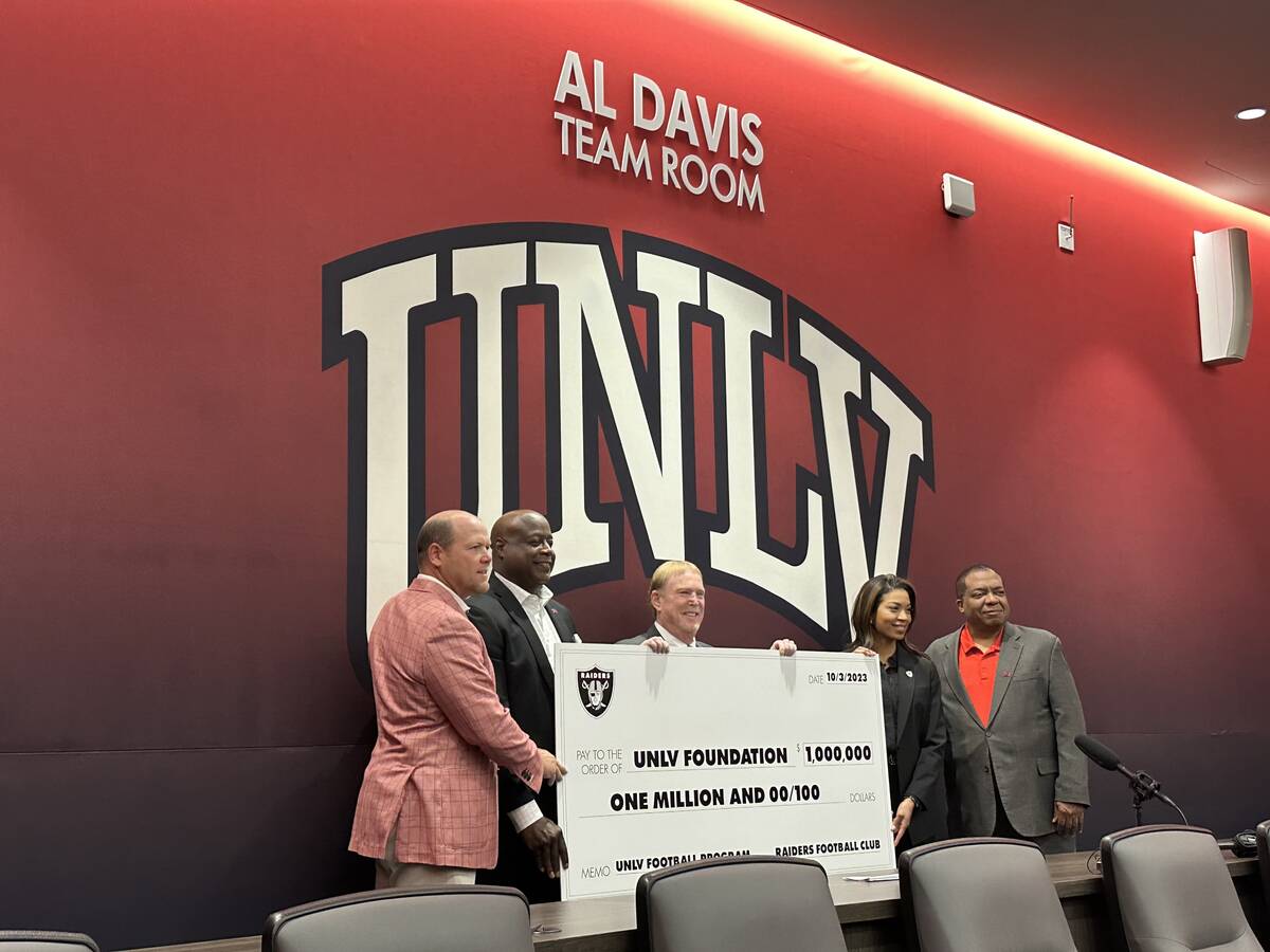 UNLV Football head coach Barry Odom (left), UNLV Athletic Director Erick Harper, Raiders owner ...