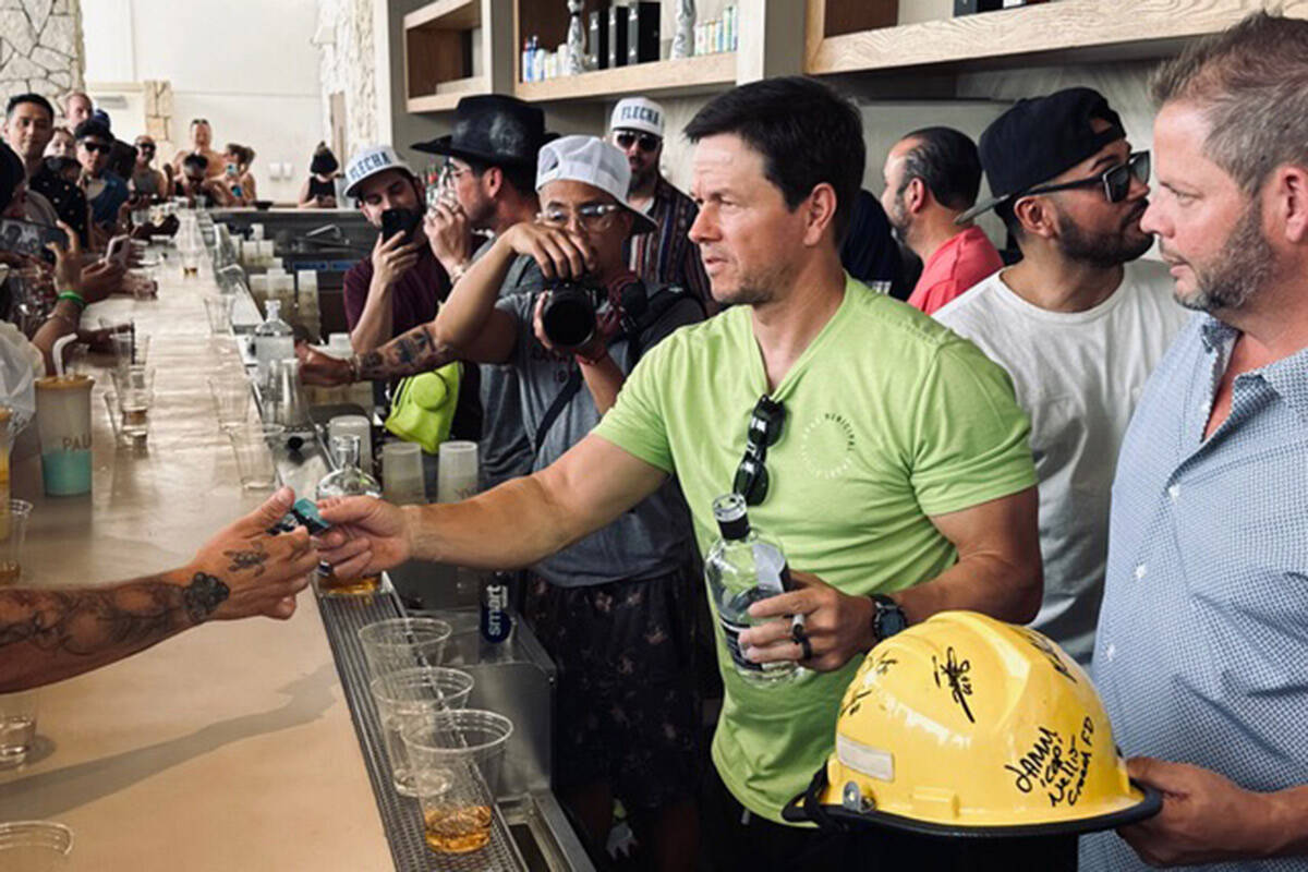 Actor and entrepreneur Mark Wahlberg is shown pouring shots of his Flecha Azul tequila at KAOS ...