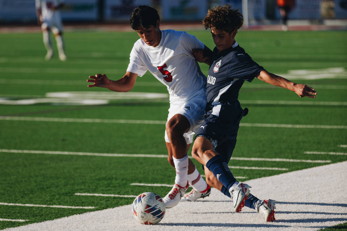 Arbor View midfielder Gabriel Estrada (5) fights with Coronado’s Cy Adams (20) for the ball d ...