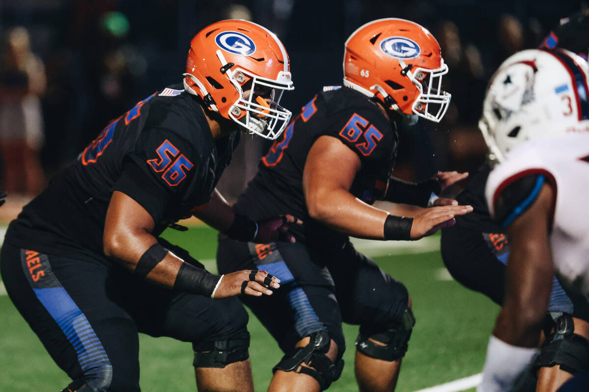 Bishop Gorman offensive linemen Doug Utu (56) and SJ Seuseu Alofaituli (65) position themselves ...