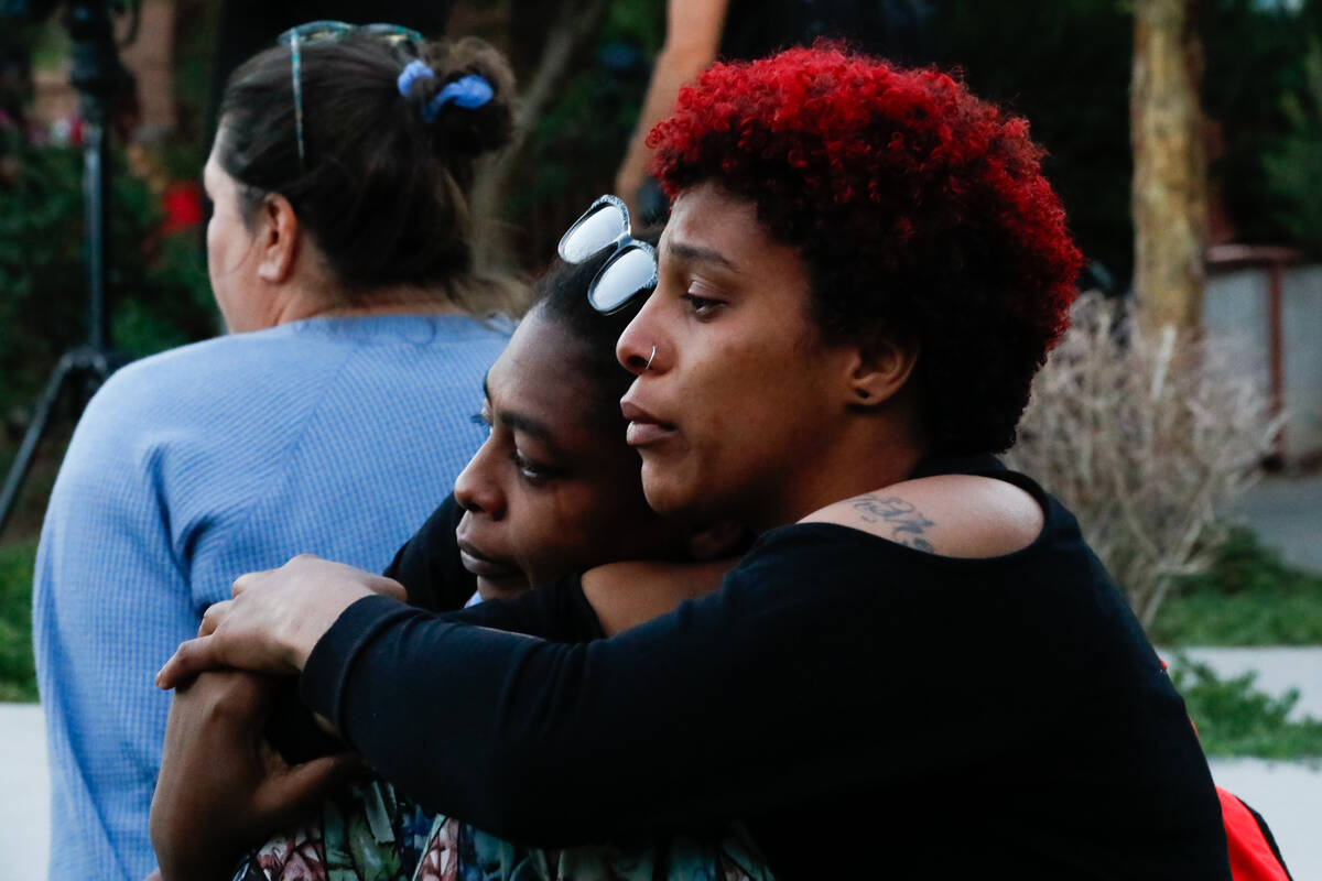 Haley Ramis, right, and Marva Smith mourn during a vigil for domestic abuse victims held at The ...