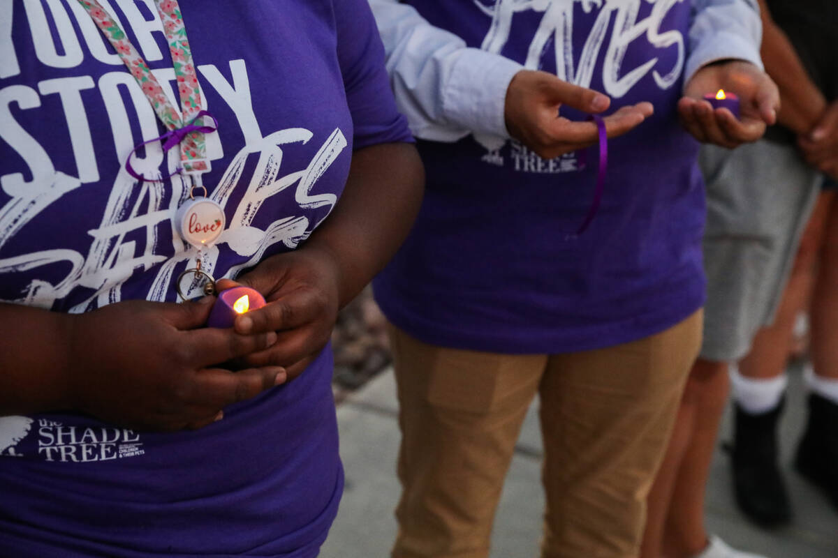 Survivors of domestic abuse gather together for a vigil honoring domestic abuse victims held at ...