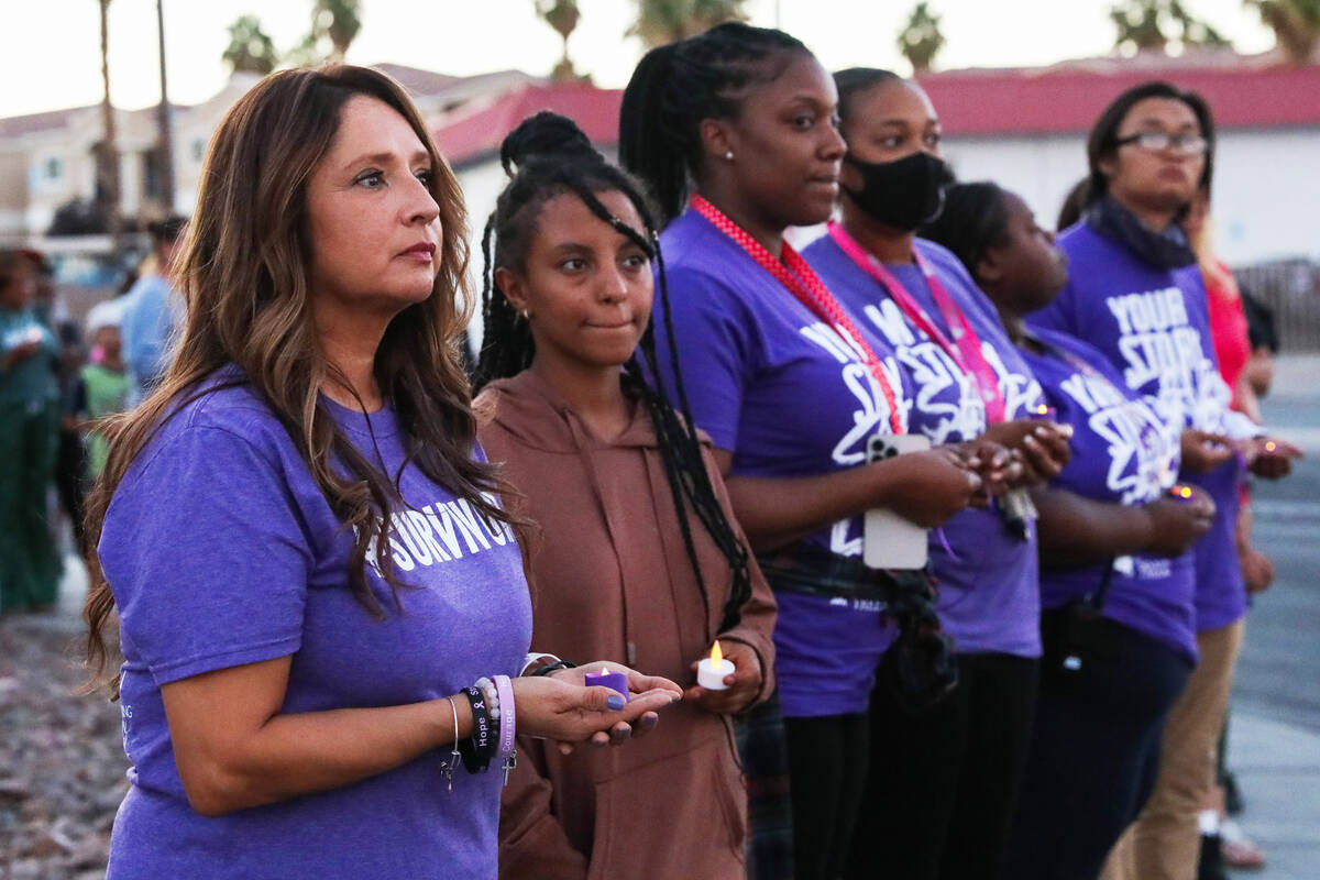 Linda Perez, CEO of The Shade Tree, gathers with other survivors of domestic abuse in front of ...