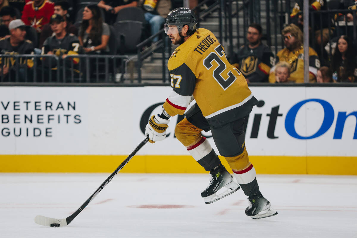 Golden Knights defenseman Shea Theodore (27) skates the puck across the ice during a game again ...