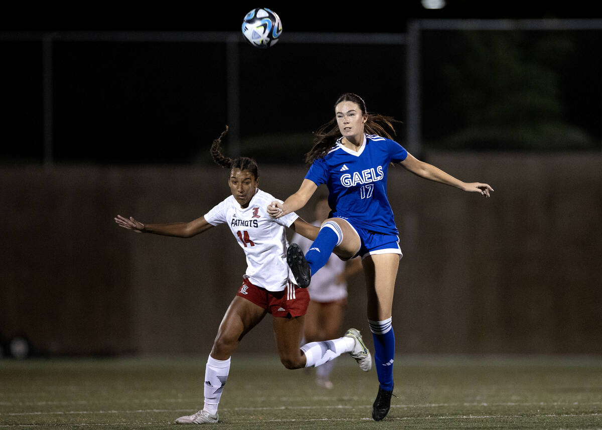 Liberty's Ayva Jordan (14) and Bishop Gorman defender Brooke Pomerantz (17) rush for the ball d ...