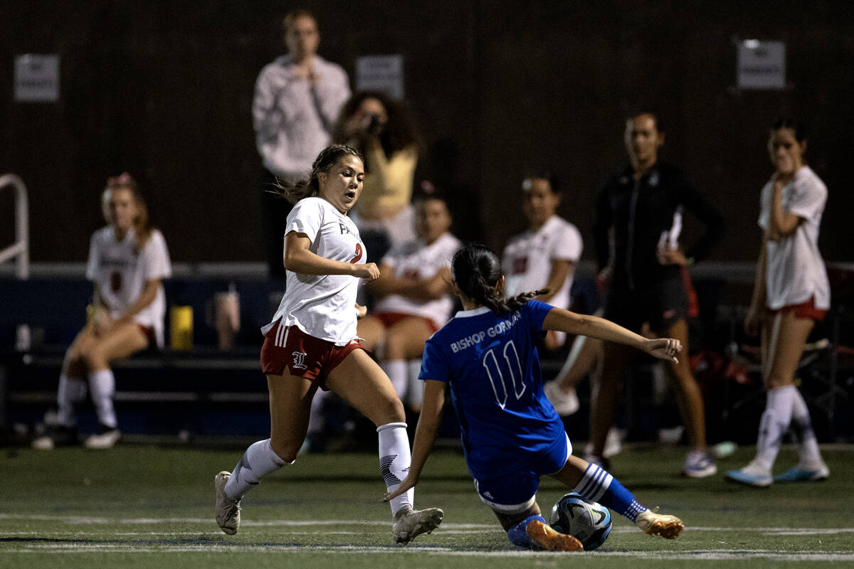 Bishop Gorman midfielder Robyn Dizon (11) thwarts a ru by Liberty midfielder Natalie Collins (2 ...