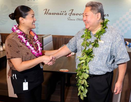 CEO Jason Higa, whose family founded Zippy’s in 1966, greets server Mia Icamen before th ...