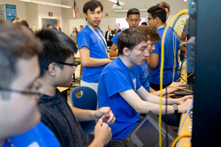 FILE - Computer science juniors work on a project in class during a tour to individuals repres ...