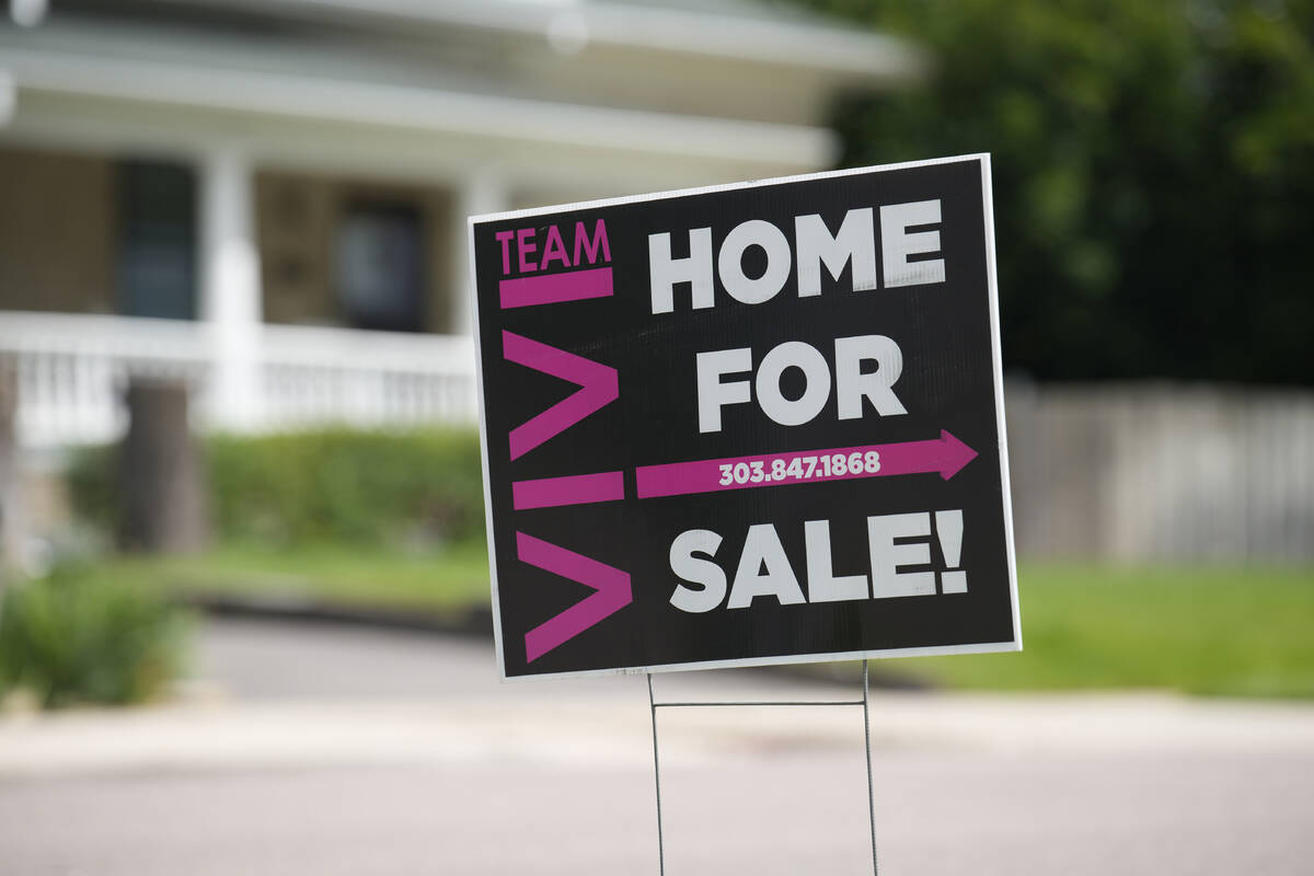 A for sale sign stands outside a single-family residence on Sunday, June 18, 2023, in Denver. ( ...